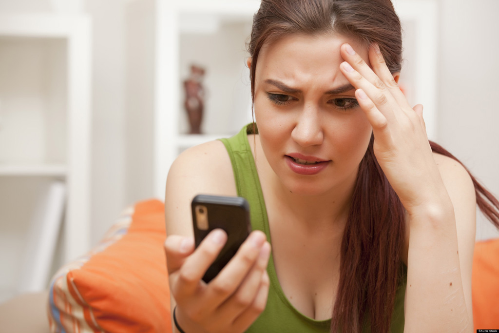 shocked and frustrated woman with cellphone; Shutterstock ID 79595149; PO: The Huffington Post; Job: The Huffington Post; Client: The Huffington Post; Other: The Huffington Post