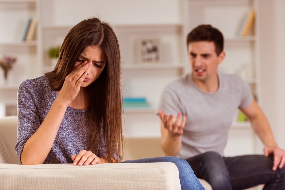 Young couple quarrels among themselves at home, his wife was crying because her husband, at home