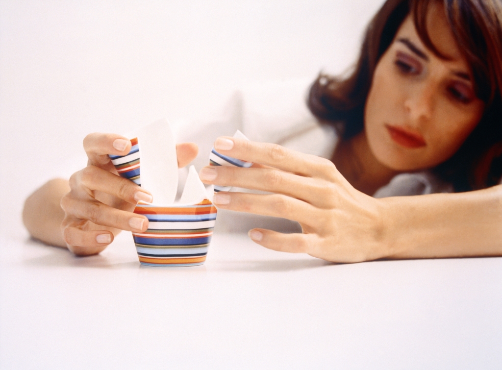 Young Woman with Broken Cup --- Image by © Holger Winkler/A.B./Corbis
