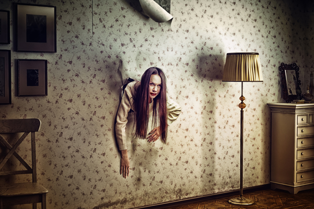 angry woman climbs through the wall into the room (photo and hand-drawing elements compilation. texture and grain add)
