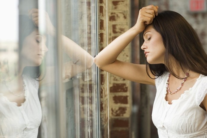 Woman Staring Out Window --- Image by © Rick Gomez/Corbis